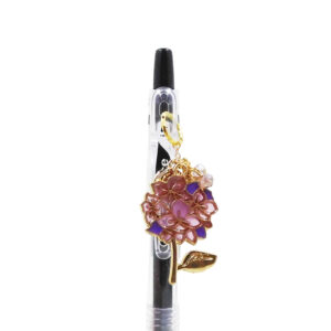Ajisai charm pen with lavender hydrangea flower charm and purple bead accents on black Pilot Juice gel pen
