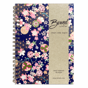 Aoi wire-bound Japanese washi notebook with pink sakura, colorful temari ornaments, and gold geometric patterns on an indigo chiyogami background