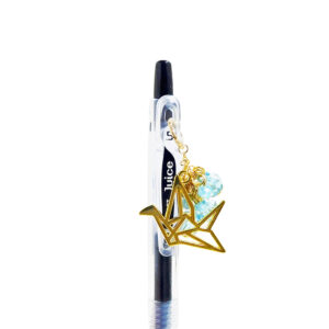 Paper tsuru charm pen with gold origami crane charm and turquoise beads on black Pilot Juice gel pen