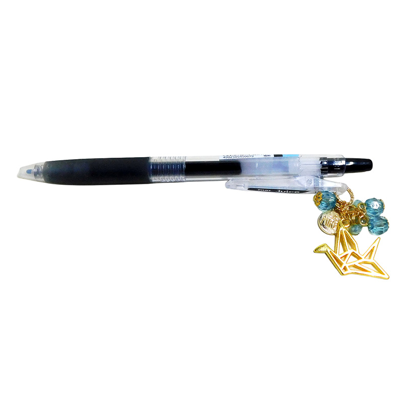 Paper tsuru charm pen side view showing gold crane charm and turquoise bead accents