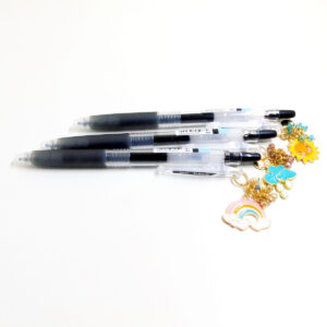 Full view of Daily Forecast Charm Pen Trio by love MIREI with sun, rain cloud, and rainbow enamel charms