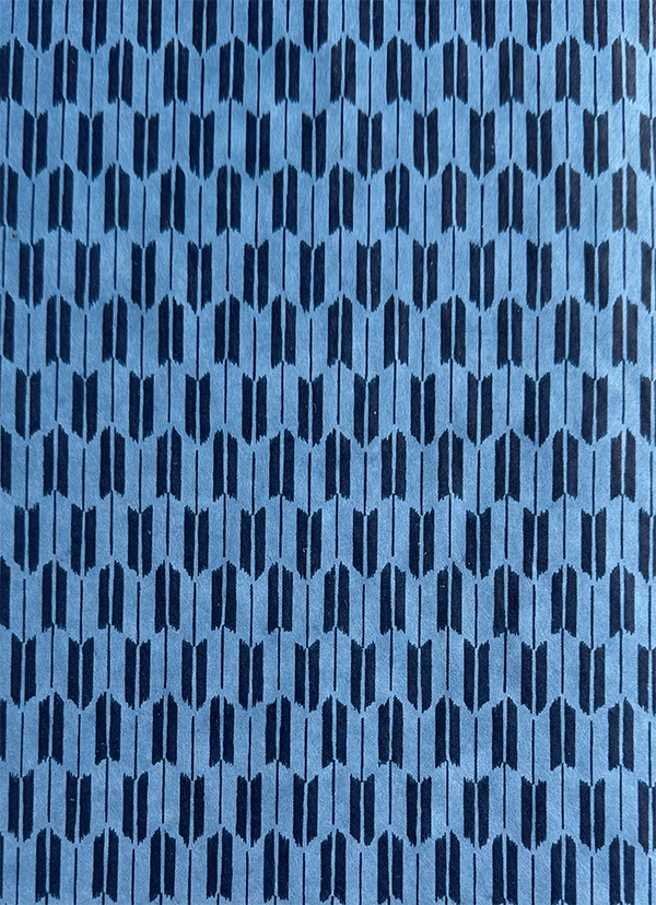 Yagasuri Indigo Japanese chiyogami pattern with repeating dark indigo arrow-feather motif on a light blue background